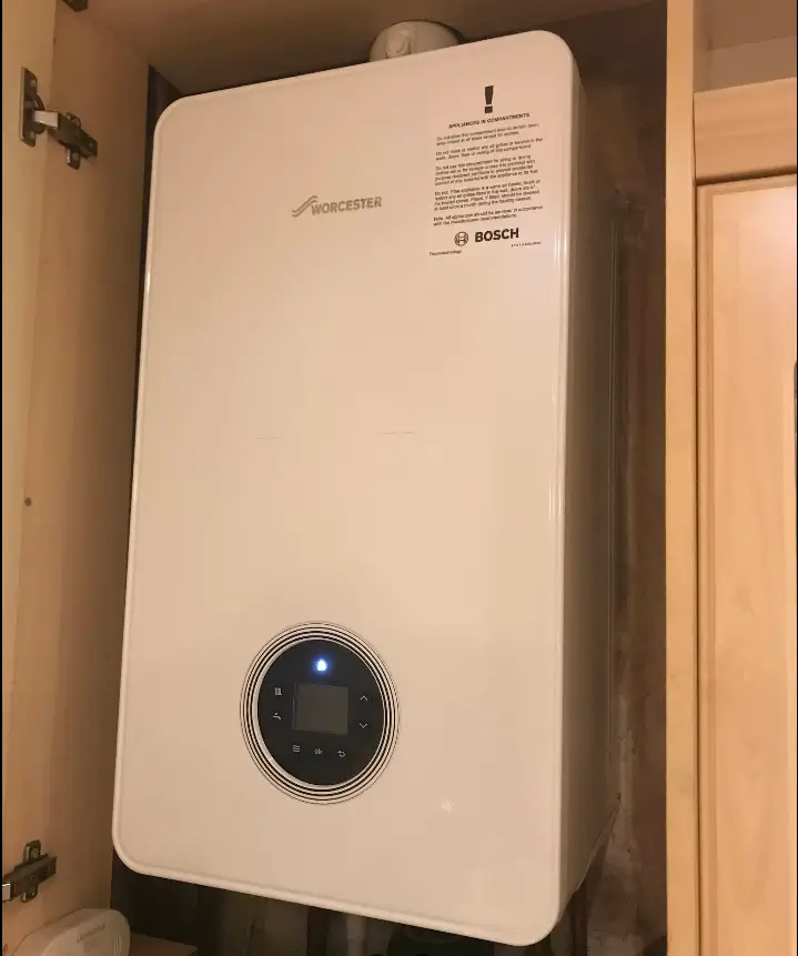 Wall-mounted Worcester Bosch boiler in cupboard